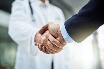  doctor shaking hands with a businessman