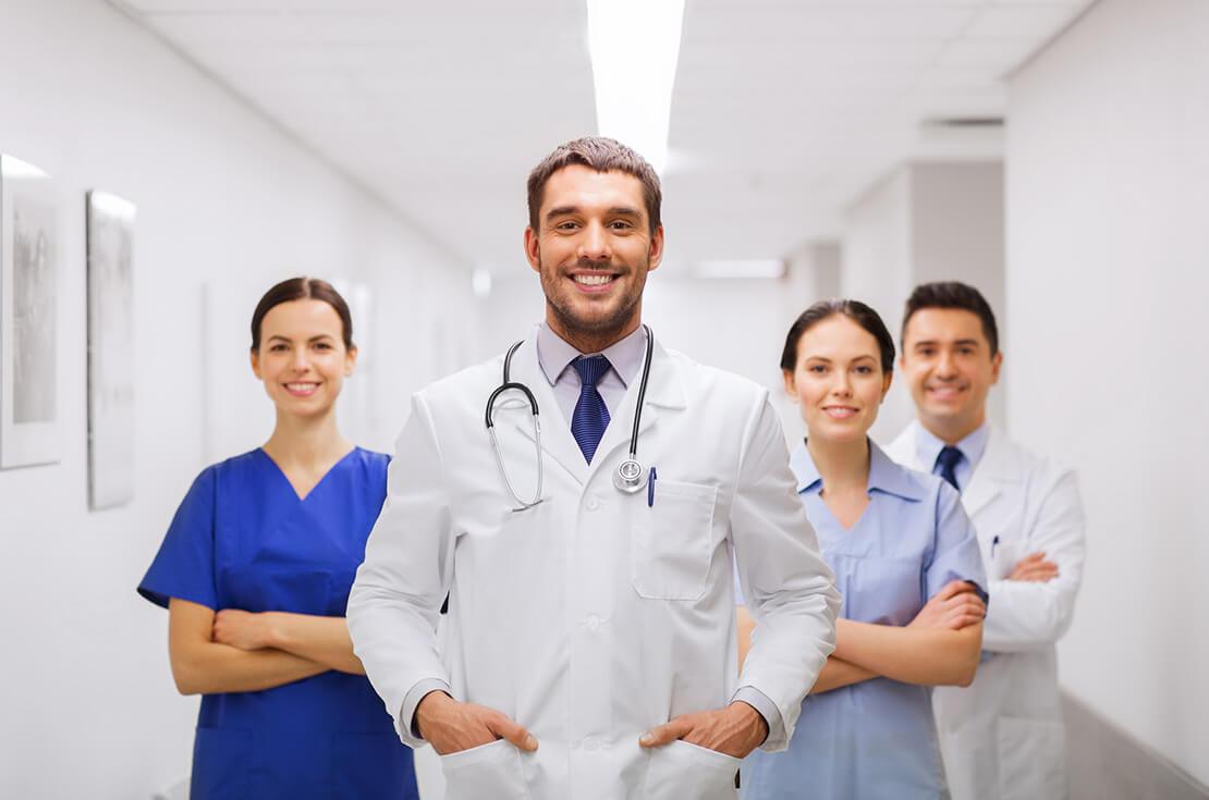 Happy group of medics or doctors at hospital 